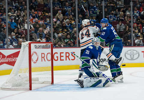 Oct 30, 2021; Vancouver, British Columbia, CAN; Edmonton Oilers forward Zack Kassian (44) checks Vancouver Canucks defenseman Tyler Myers (57) as goalie Thatcher Demko (35) makes a save in the second period at Rogers Arena. Mandatory Credit: Bob Frid-USA TODAY Sports