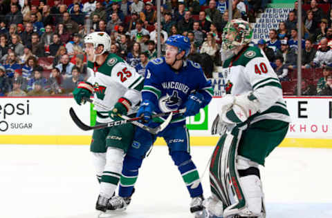 VANCOUVER, BC – DECEMBER 4: Jonas Brodin #25 of the Minnesota Wild and Brock Boeser #6 of the Vancouver Canucks stand in front of Devan Dubnyk #40 of the Minnesota Wild during their NHL game at Rogers Arena December 4, 2018, in Vancouver, British Columbia, Canada. (Photo by Jeff Vinnick/NHLI via Getty Images)”n