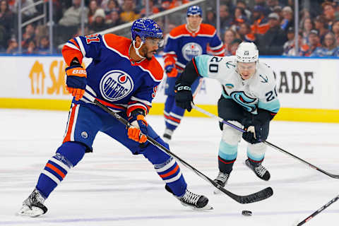 Oct 6, 2023; Edmonton, Alberta, CAN; Edmonton Oilers forward Evander Kane (91) looks to make a pass in front of Seattle Kraken forward Eeli Tolvannen (20) during the first period at Rogers Place. Mandatory Credit: Perry Nelson-USA TODAY Sports