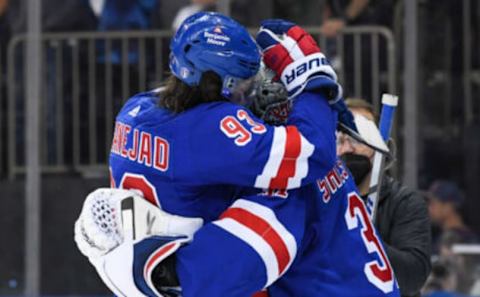 May 11, 2022; New York, New York, USA; New York Rangers center Mika Zibanejad (93) congratulates New York Rangers goaltender Igor Shesterkin (31) on beating the Pittsburgh Penguins 4-3 after game five of the first round of the 2022 Stanley Cup Playoffs at Madison Square Garden. Mandatory Credit: Dennis Schneidler-USA TODAY Sports