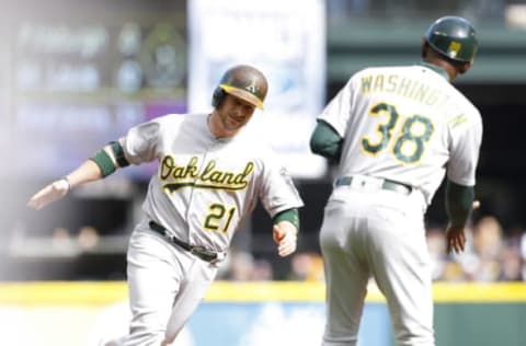 Oct 2, 2016; Seattle, WA, USA; Oakland Athletics designated hitter Stephen Vogt (21) celebrates with third base coach Ron Washington (38) after hitting a home run against the Seattle Mariners during the first inning at Safeco Field. Mandatory Credit: Jennifer Buchanan-USA TODAY Sports