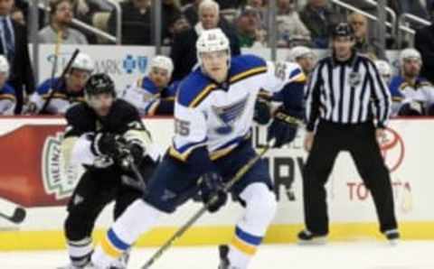 Nov 25, 2015; Pittsburgh, PA, USA; St. Louis Blues defenseman Colton Parayko (55) moves the puck as Pittsburgh Penguins center Matt Cullen (7) pressures during the third period at the CONSOL Energy Center. The Penguins won 4-3 in overtime. Mandatory Credit: Charles LeClaire-USA TODAY Sports