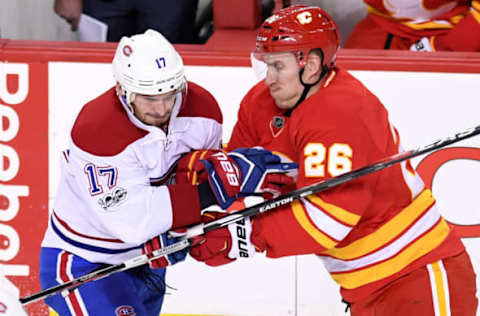 Mar 9, 2017; Calgary, Alberta, CAN; Montreal Canadiens center Torrey Mitchell (17) and Calgary Flames defenseman Michael Stone (26) collide in the third period at Scotiabank Saddledome. The Flames won 5-0. Mandatory Credit: Candice Ward-USA TODAY Sports