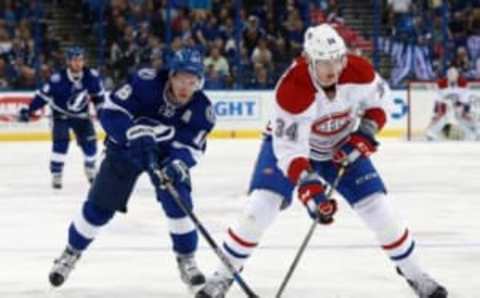 Mar 31, 2016; Tampa, FL, USA; Montreal Canadiens right wing Michael McCarron (34) skates with the puck as Tampa Bay Lightning left wing Ondrej Palat (18) defends during the first period at Amalie Arena. Mandatory Credit: Kim Klement-USA TODAY Sports