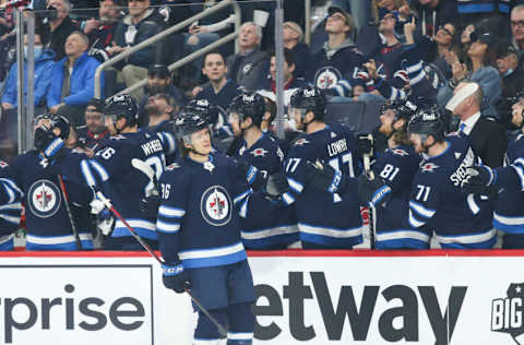 May 1, 2022; Winnipeg, Manitoba, CAN; Winnipeg Jets forward Morgan Barron (36) is congratulated by his team mates on his goal against the Seattle Kraken during the first period at Canada Life Centre. Mandatory Credit: Terrence Lee-USA TODAY Sports