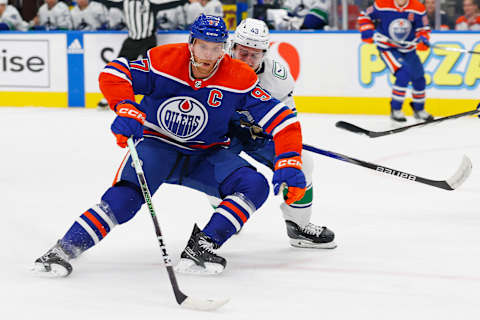 Sep 27, 2023; Edmonton, Alberta, CAN; Edmonton Oilers forward Connor McDavid (97) carries the puck around Vancouver Canucks defensemen Quinn Hughes (43) during the first period at Rogers Place. Mandatory Credit: Perry Nelson-USA TODAY Sports