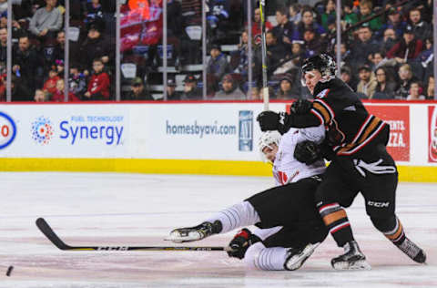 CALGARY, AB – DECEMBER 2: Ryder Korczak #14 of the Calgary Hitmen checks Kaeden Taphorn #22 of the Moose Jaw Warriors during a WHL game at the Scotiabank Saddledome on December 2, 2018, in Calgary, Alberta, Canada. (Photo by Derek Leung/Getty Images)