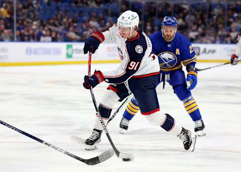 Feb 28, 2023; Buffalo, New York, USA; Columbus Blue Jackets center Kent Johnson (91) takes a shot on goal and scores during the first period against the Buffalo Sabres at KeyBank Center. Mandatory Credit: Timothy T. Ludwig-USA TODAY Sports