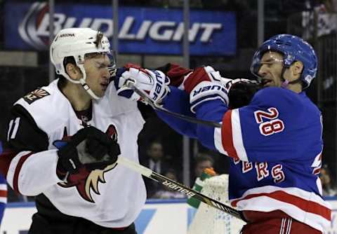 Oct 22, 2015; New York, NY, USA; New York Rangers center Dominic Moore (28) and Arizona Coyotes center Martin Hanzal (11) fight during the first period of an NHL hockey game at Madison Square Garden. Mandatory Credit: Adam Hunger-USA TODAY Sports