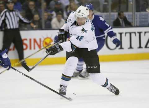 Dec 17, 2015; Toronto, Ontario, CAN; San Jose Sharks forward Patrick Marleau (12) shoots the puck against the Toronto Maple Leafs at the Air Canada Centre. San Jose defeated Toronto 5-4 in overtime. Mandatory Credit: John E. Sokolowski-USA TODAY Sports