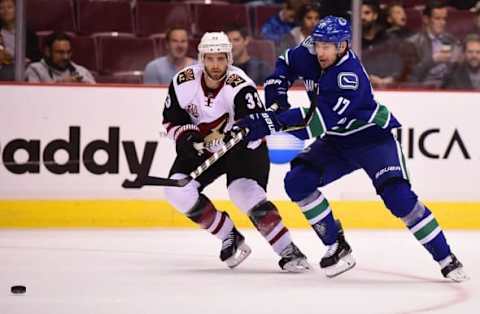 Oct 3, 2016; Vancouver, British Columbia, CAN; Vancouver Canucks forward Anton Rodin (17) and Arizona Coyotes defenseman Alex Goligoski (33) battle for the puck during a preseason hockey game at Rogers Arena. Mandatory Credit: Anne-Marie Sorvin-USA TODAY Sports