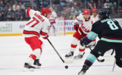 Oct 19, 2023; Seattle, Washington, USA; Carolina Hurricanes defenseman Tony DeAngelo (77) plays the puck against the Seattle Kraken during the second period at Climate Pledge Arena. Mandatory Credit: Steven Bisig-USA TODAY Sports