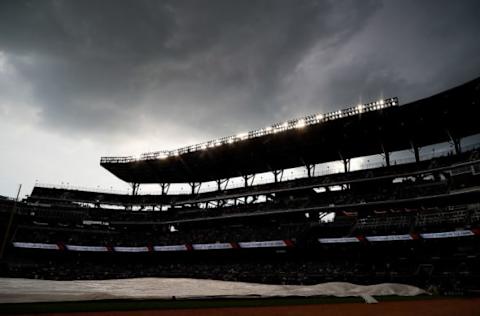 ATLANTA, GA – JULY 17: The grounds crew pulls the tarp over the infield prior to a rain delay in the game between the Atlanta Braves and the Chicago Cubs at SunTrust Park on July 17, 2017 in Atlanta, Georgia. (Photo by Kevin C. Cox/Getty Images)