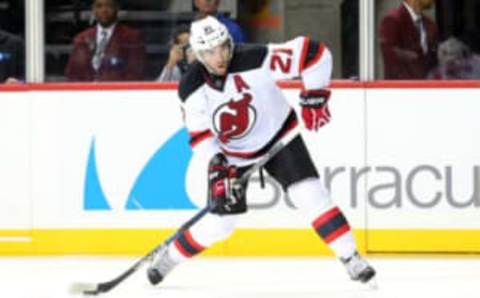 Sep 23, 2015; Brooklyn, NY, USA; New Jersey Devils right wing Kyle Palmieri (21) takes a shot against the New York Islanders during the first period at Barclays Center. Mandatory Credit: Brad Penner-USA TODAY Sports