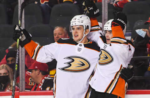 CALGARY, AB – OCTOBER 18: Jamie Drysdale #34 (R) of the Anaheim Ducks celebrates with his teammate Troy Terry #19 after scoring in overtime against the Calgary Flames during an NHL game at Scotiabank Saddledome on October 18, 2021 in Calgary, Alberta, Canada. (Photo by Derek Leung/Getty Images)