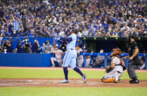 TORONTO, ONTARIO – OCTOBER 3: George Springer #4 of the Toronto Blue Jays hits a grand slam home run against the Baltimore Orioles in the third inning during their MLB game at the Rogers Centre on October 3, 2021 in Toronto, Ontario, Canada. (Photo by Mark Blinch/Getty Images)