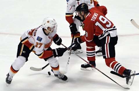 Nov 1, 2016; Chicago, IL, USA; Chicago Blackhawks center Jonathan Toews (19) is defended by Calgary Flames defenseman Dougie Hamilton (27) during the third period at the United Center. The Hawks won 5-1. Mandatory Credit: David Banks-USA TODAY Sports