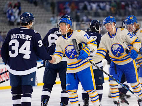 Mar 13, 2022; Hamilton, Ontario, CAN; Toronto Maple Leafs forward Auston Matthews (34) and Buffalo Sabres forward Cody Eakin (20) and Buffalo Sabres forward Casey Mittelstadt (37) shakes hands after the end of the game in the 2022 Heritage Classic ice hockey game at Tim Hortons Field. Mandatory Credit: John E. Sokolowski-USA TODAY Sports