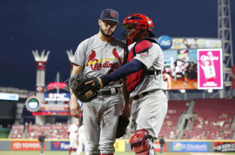 CINCINNATI, OH – JULY 23: Daniel Poncedeleon #62 of the St. Louis Cardinals gets a hug from Yadier Molina #4 after pitching the seventh inning against the Cincinnati Reds during a game at Great American Ball Park on July 23, 2018 in Cincinnati, Ohio. Poncedeleon came out of the game after pitching a no-hitter through seven innings but the Reds won 2-1. (Photo by Joe Robbins/Getty Images)