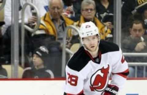 Jan 26, 2016; Pittsburgh, PA, USA; New Jersey Devils defenseman Damon Severson (28) handles the puck against the Pittsburgh Penguins during the third period at the CONSOL Energy Center. The Penguins won 2-0. Mandatory Credit: Charles LeClaire-USA TODAY Sports