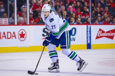 Apr 7, 2016; Calgary, Alberta, CAN; Vancouver Canucks defenseman Ben Hutton (27) controls the puck against the Calgary Flames during the first period at Scotiabank Saddledome. Calgary Flames won 7-3. Mandatory Credit: Sergei Belski-USA TODAY Sports