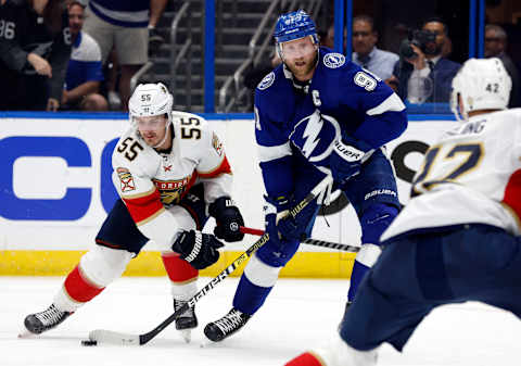 May 23, 2022; Tampa, Florida, USA; Tampa Bay Lightning center Steven Stamkos (91) passes the puck as Florida Panthers center Noel Acciari (55) defends during the third period at Amalie Arena. Mandatory Credit: Kim Klement-USA TODAY Sports