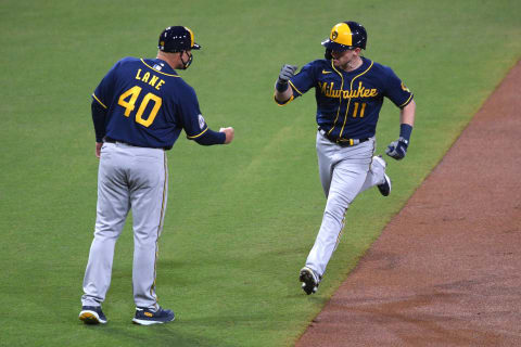 Apr 20, 2021; San Diego, California, USA; Milwaukee Brewers left fielder Billy McKinney (11) is congratulated by third base coach Jason Lane (40) after hitting a home run against the San Diego Padres during the third inning at Petco Park. Mandatory Credit: Orlando Ramirez-USA TODAY Sports