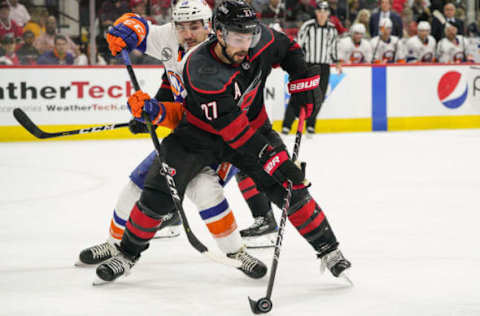 RALEIGH, NC – MAY 03: Carolina Hurricanes defenseman Justin Faulk (27) steals a puck from New York Islanders left wing Michael Dal Colle (28) during a game between the Carolina Hurricanes and the New York Islanders on March 3, 2019 at the PNC Arena in Raleigh, NC. (Photo by Greg Thompson/Icon Sportswire via Getty Images)