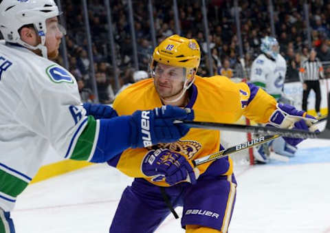 Mar 7, 2016; Los Angeles, CA, USA; Los Angeles Kings left wing Kyle Clifford (13) checks Vancouver Canucks defenseman Yannick Weber (6) into the boards in the second period of the game at Staples Center. Mandatory Credit: Jayne Kamin-Oncea-USA TODAY Sports