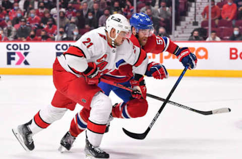 MONTREAL, QC – OCTOBER 21: Nino Niederreiter #21 of the Carolina Hurricanes and David Savard #58 of the Montreal Canadiens skate against each other during the first period at Centre Bell on October 21, 2021, in Montreal, Canada. (Photo by Minas Panagiotakis/Getty Images)