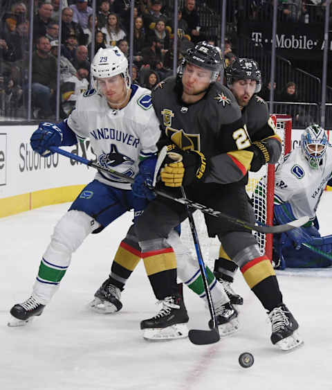 LAS VEGAS, NV – FEBRUARY 23: Philip Holm #29 of the Vancouver Canucks and Stefan Matteau #25 of the Vegas Golden Knights collide in front of Alex Tuch #89 of the Golden Knights as they go after the puck in the second period of their game at T-Mobile Arena on February 23, 2018 in Las Vegas, Nevada. (Photo by Ethan Miller/Getty Images)