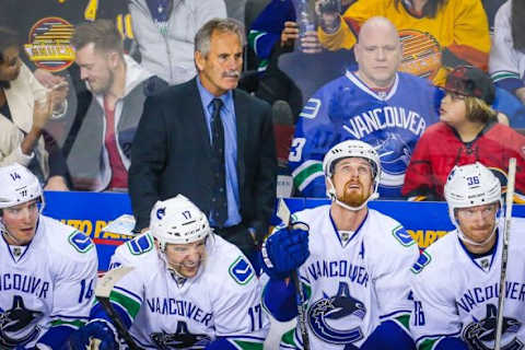 Feb 19, 2016; Calgary, Alberta, CAN; Vancouver Canucks head coach Willie Desjardins watches from his bench against the Calgary Flames during the third period at Scotiabank Saddledome. Calgary Flames won 5-2. Mandatory Credit: Sergei Belski-USA TODAY Sports