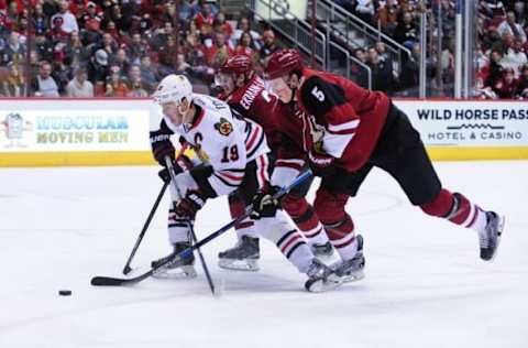 Dec 29, 2015; Glendale, AZ, USA; Chicago Blackhawks center Jonathan Toews (19) carries the puck past Arizona Coyotes defenseman Connor Murphy (5) and defenseman Oliver Ekman-Larsson (23) during the third period at Gila River Arena. Mandatory Credit: Matt Kartozian-USA TODAY Sports