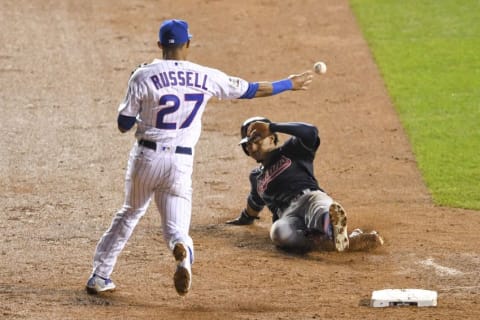 Chicago Cubs shortstop Addison Russell (27) completes a double play against Cleveland Indians counterpart shortstop Francisco Lindor (right) during the third inning in game four of the 2016 World Series at Wrigley Field. Mandatory Credit: Dennis Wierzbicki-USA TODAY Sports