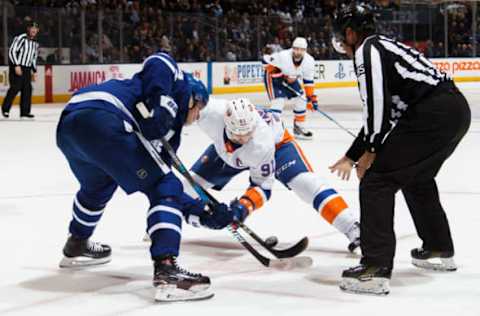 TORONTO, ON – JANUARY 31: Auston Matthews #34 of the Toronto Maple Leafs takes a face-off against John Tavares #91 of the New York Islanders during the third period at the Air Canada Centre on January 31, 2018 in Toronto, Ontario, Canada. (Photo by Kevin Sousa/NHLI via Getty Images)