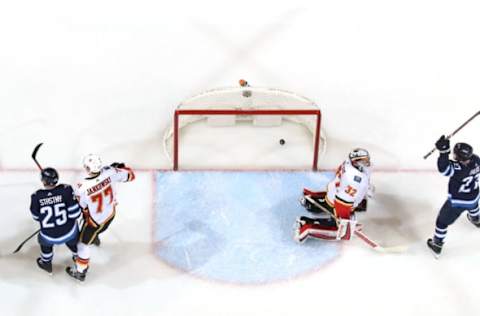 WINNIPEG, MB – APRIL 5: Nikolaj Ehlers #27 of the Winnipeg Jets raises his stick in celebration after teammate Paul Stastny #25 deflects the puck past goaltender Jon Gillies #32 of the Calgary Flames for a second period goal at the Bell MTS Place on April 5, 2018 in Winnipeg, Manitoba, Canada. (Photo by Jonathan Kozub/NHLI via Getty Images)