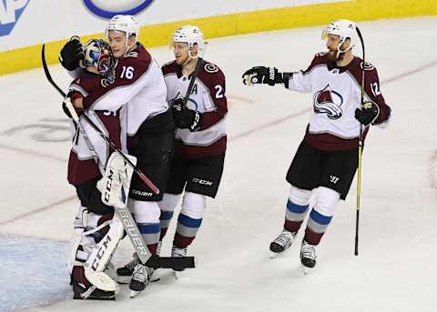 CALGARY, AB – APRIL 19: Colorado Avalanche goaltender Philipp Grubauer (31) greets teammate defenseman Nikita Zadorov (16), center Nathan MacKinnon (29) and Colorado Avalanche defenseman Patrik Nemeth (12) after defeating the Calgary Flames 5-1 to take the series 4-1 in the at the Scotiabank Saddledome for game five playoffs April 19, 2019. (Photo by Andy Cross/MediaNews Group/The Denver Post via Getty Images)