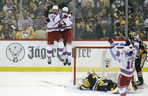 May 13, 2022; Pittsburgh, Pennsylvania, USA; New York Rangers left wing Chris Kreider (20) and center Mika Zibanejad (93) celebrate a goal by Kreider against Pittsburgh Penguins goaltender Louis Domingue (70) during the second period in game six of the first round of the 2022 Stanley Cup Playoffs at PPG Paints Arena. Mandatory Credit: Charles LeClaire-USA TODAY Sports