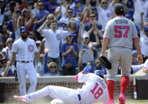 May 8, 2016; Chicago, IL, USA; Chicago Cubs second baseman Ben Zobrist (18) scores a run on a wild pitch by Washington Nationals starting pitcher Tanner Roark (57) during the fourth inning at Wrigley Field. Mandatory Credit: David Banks-USA TODAY Sports