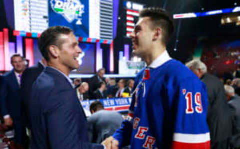 VANCOUVER, BRITISH COLUMBIA – JUNE 22: Matthew Robertson, 49th overall pick of the New York Rangers, is greeted by head coach Dave Quinn of the New York Rangers at the draft table during Rounds 2-7 of the 2019 NHL Draft at Rogers Arena on June 22, 2019 in Vancouver, Canada. (Photo by Jeff Vinnick/NHLI via Getty Images)