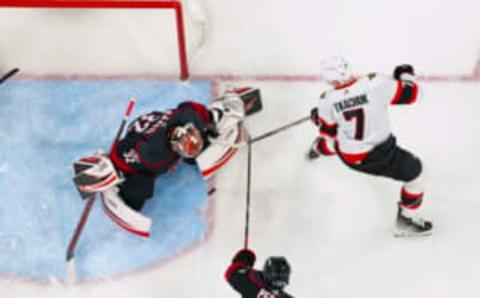 Feb 21, 2023; Raleigh, North Carolina, USA; Carolina Hurricanes goaltender Antti Raanta (32) stops the shot by Ottawa Senators left wing Brady Tkachuk (7) during the third period at PNC Arena. Mandatory Credit: James Guillory-USA TODAY Sports