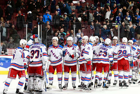 VANCOUVER, BC – FEBRUARY 28: Henrik Lundqvist #30 of the New York Rangers is congratulated by teammates after after their overtime win during their NHL game against the Vancouver Canucks at Rogers Arena February 28, 2018 in Vancouver, British Columbia, Canada. (Photo by Jeff Vinnick/NHLI via Getty Images)”n