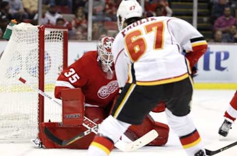 Nov 20, 2016; Detroit, MI, USA; Detroit Red Wings goalie Jimmy Howard (35) makes a save against Calgary Flames right wing Michael Frolik (67) during the second period at Joe Louis Arena. Flames won 3-2. Mandatory Credit: Raj Mehta-USA TODAY Sports