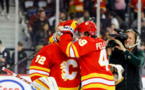 CALGARY, CANADA – APRIL 12: Dustin Wolf #32 of the Calgary Flames celebrates with Jakob Pelletier #49 of the Calgary Flames and other teammates after their win against the San Jose Sharks at the Scotiabank Saddledome on April 12, 2023, in Calgary, Alberta, Canada. (Photo by Leah Hennel/Getty Images)