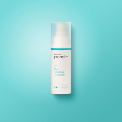 A bottle of Proactiv solution on a blue background