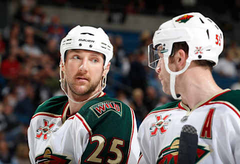 TAMPA, FL -NOVEMBER 14: Cam Barker #25 of the Minnesota Wild talks with teammate Nick Schultz #55 during a break in the action against the Tampa Bay Lightning at the St. Pete Times Forum on November 14, 2010 in Tampa, Florida. (Photo by Scott Audette/NHLI via Getty Images)