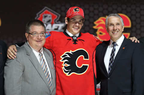 Jun 30, 2013; Newark, NJ, USA; Sean Monahan poses with team officials after being introduced as the number six overall pick to the Calgary Flames during the 2013 NHL Draft at the Prudential Center. Mandatory Credit: Ed Mulholland-USA TODAY Sports