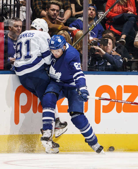 TORONTO, ON - OCTOBER 10: Cody Ceci #83 of the Toronto Maple Leafs checks Steven Stamkos #91 of the Tampa Bay Lightning during the third at the Scotiabank Arena on October 10, 2019 in Toronto, Ontario, Canada. (Photo by Mark Blinch/NHLI via Getty Images)