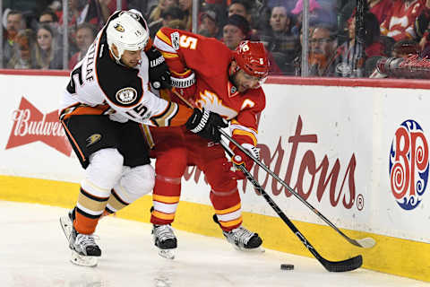 Apr 2, 2017; Calgary, Alberta, CAN; Anaheim Ducks center Ryan Getzlaf (15) and Calgary Flames defenseman Mark Giordano (5) battle for the puck in the second period at Scotiabank Saddledome. Mandatory Credit: Candice Ward-USA TODAY Sports