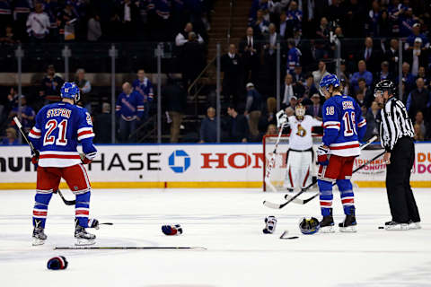 May 4, 2017; New York, NY, USA; New York Rangers center Derek Stepan (21) and New York Rangers defenseman Marc Staal (18) pick up gloves and sticks after a fight with the Ottawa Senators during the third period in game four of the second round of the 2017 Stanley Cup Playoffs at Madison Square Garden. Mandatory Credit: Adam Hunger-USA TODAY Sports